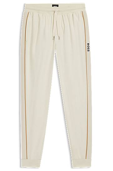 Trenirka BOSS Cotton-terry tracksuit bottoms with side tape and vertical logo Bež | 50550613