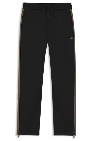 Trenirka BOSS Relaxed-fit tracksuit bottoms with logo tape and ankle zippers Črna | 50551351