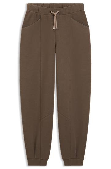 Trenirka BOSS Relaxed-fit tracksuit bottoms with lustrous piping Rjava | 50548633
