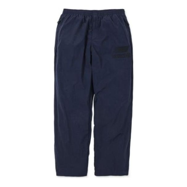 Trenirka New Balance N.HOOLYWOOD x INVINCIBLE(R) Woven Pants Modra | AMP22346-PCT