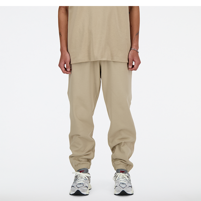 Hlače in kavbojke New Balance Trousers Bež | MP41508SOT