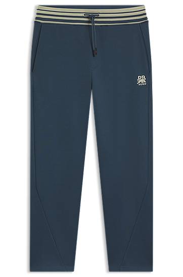 Trenirka BOSS HUGO x RB Oversized-Fit Tracksuit Bottoms with Striped Waistband and Drawstring Mornarica | 50549308